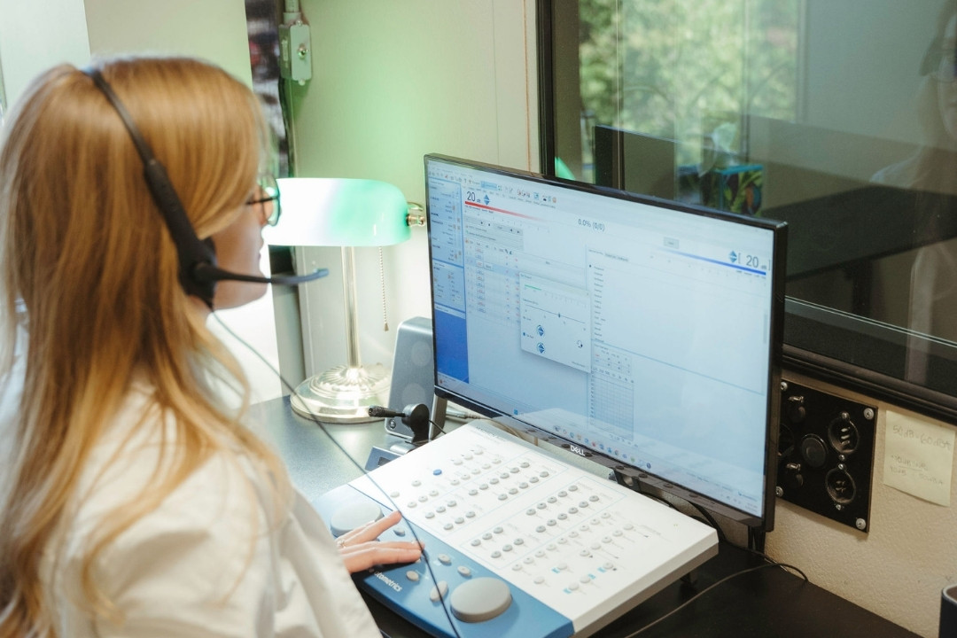 Audiologist performing a hyperacusis evaluation and sound tolerance test