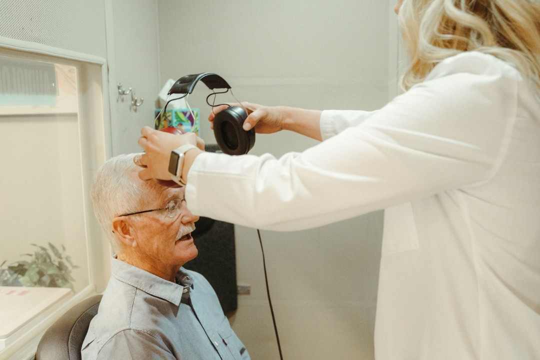 Audiologist reviewing audiogram results with a patient after a hearing evaluation