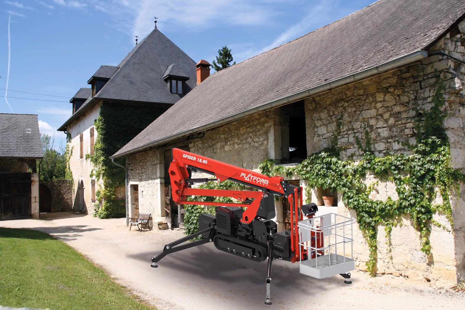 Red spider lift with extended legs parked beside an old stone building with ivy on its walls.