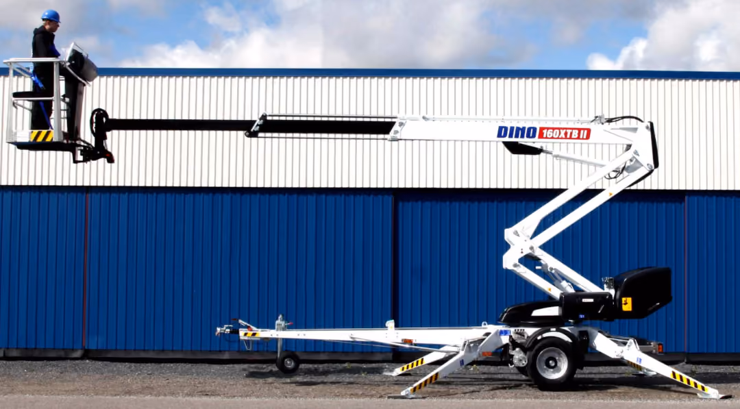 Person wearing a blue helmet operating a white Dino 160 XTB II boom lift extended horizontally.