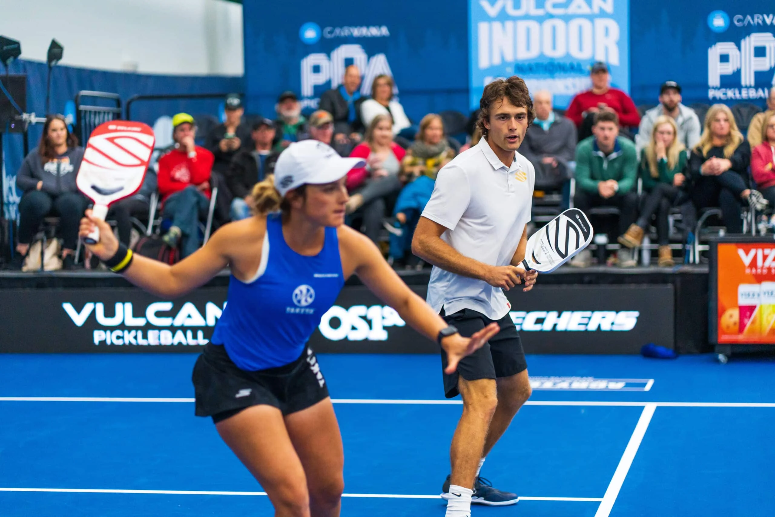 man and women team together playing pickleball