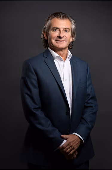 A man in a suit posing for a picture.