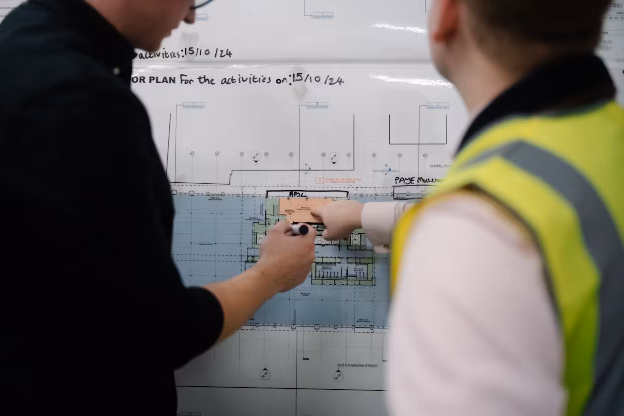Two men working on a graph