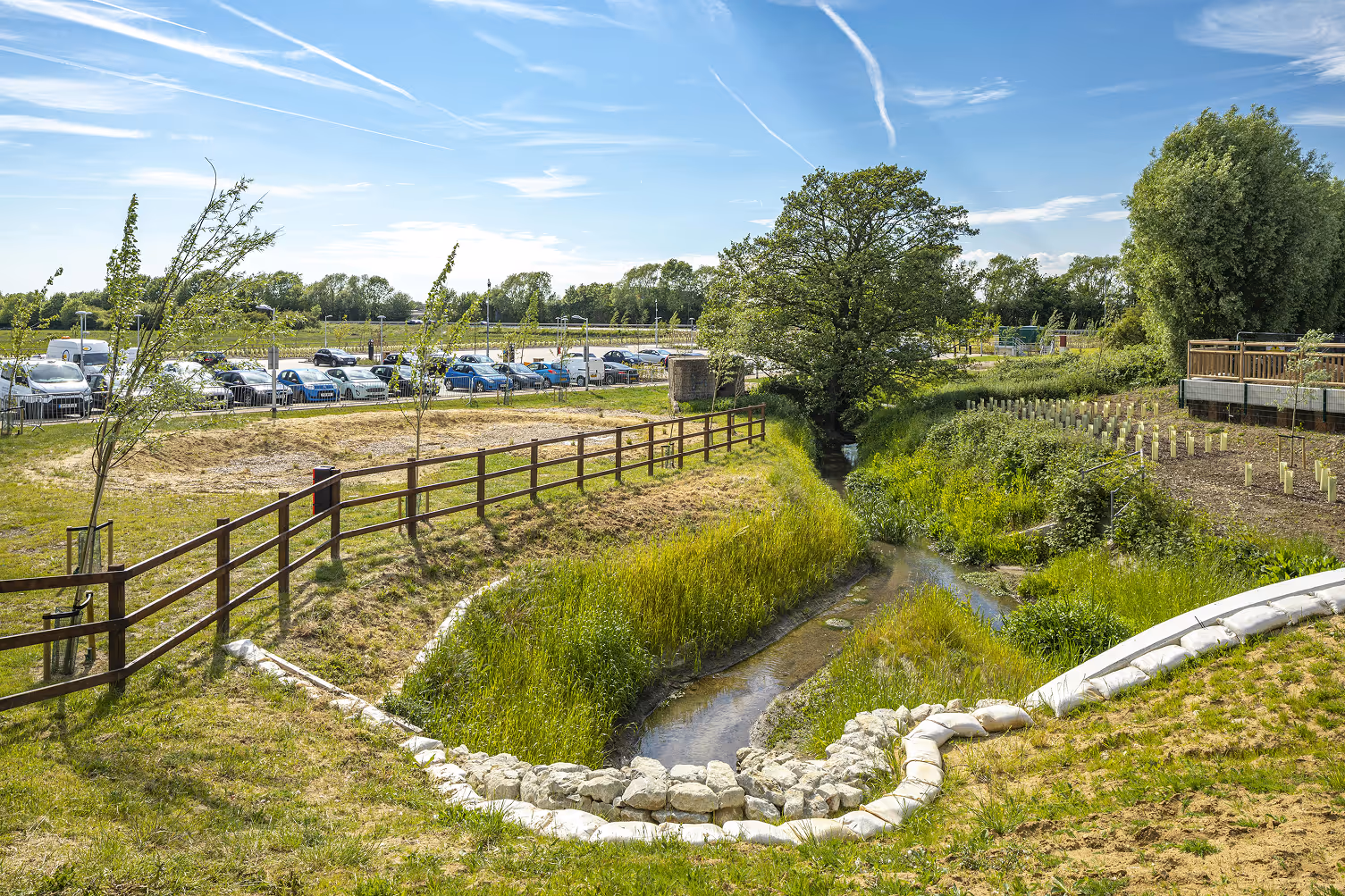 A small stream running through a lush green field.