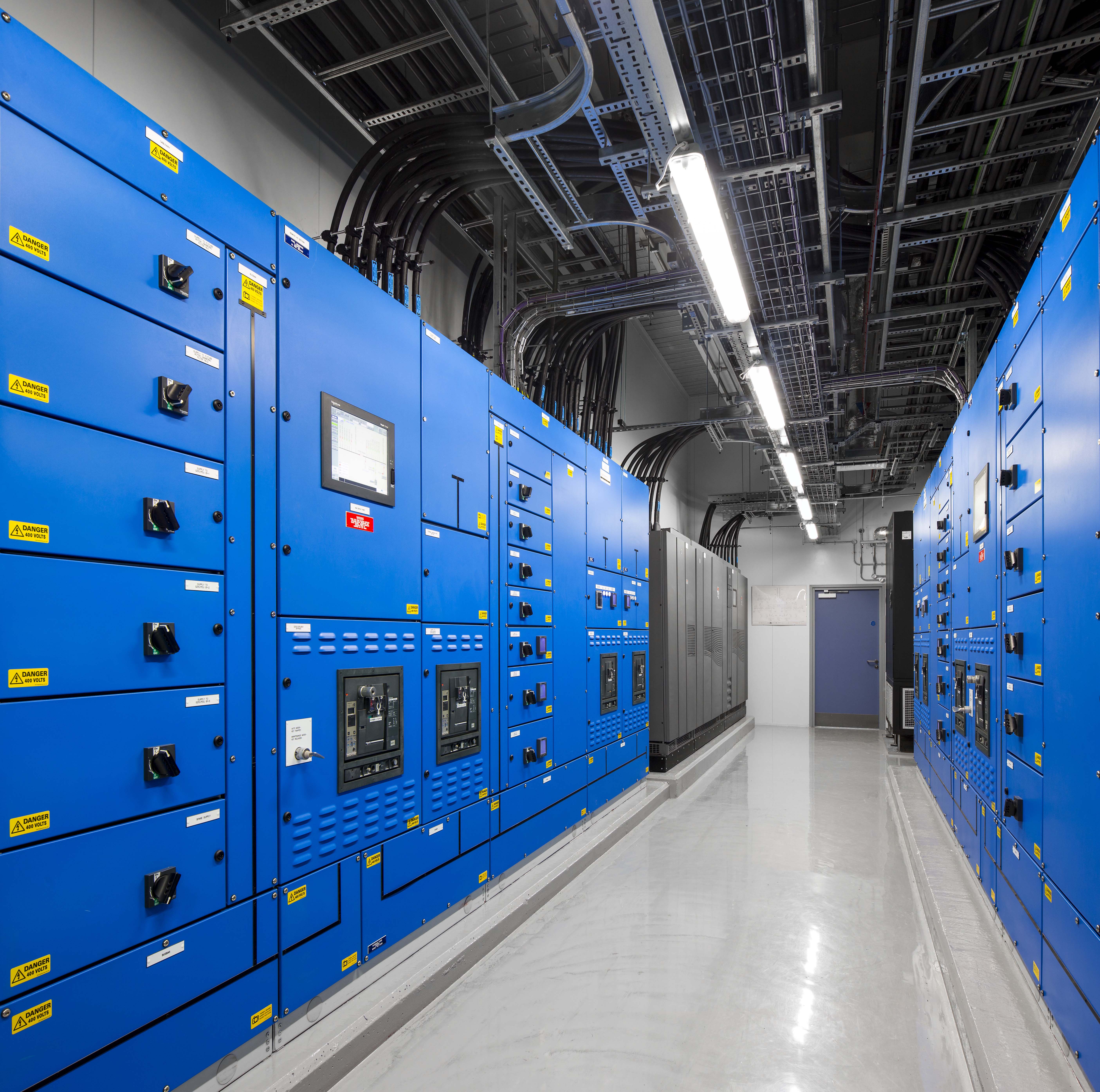 A row of blue lockers in a large room.