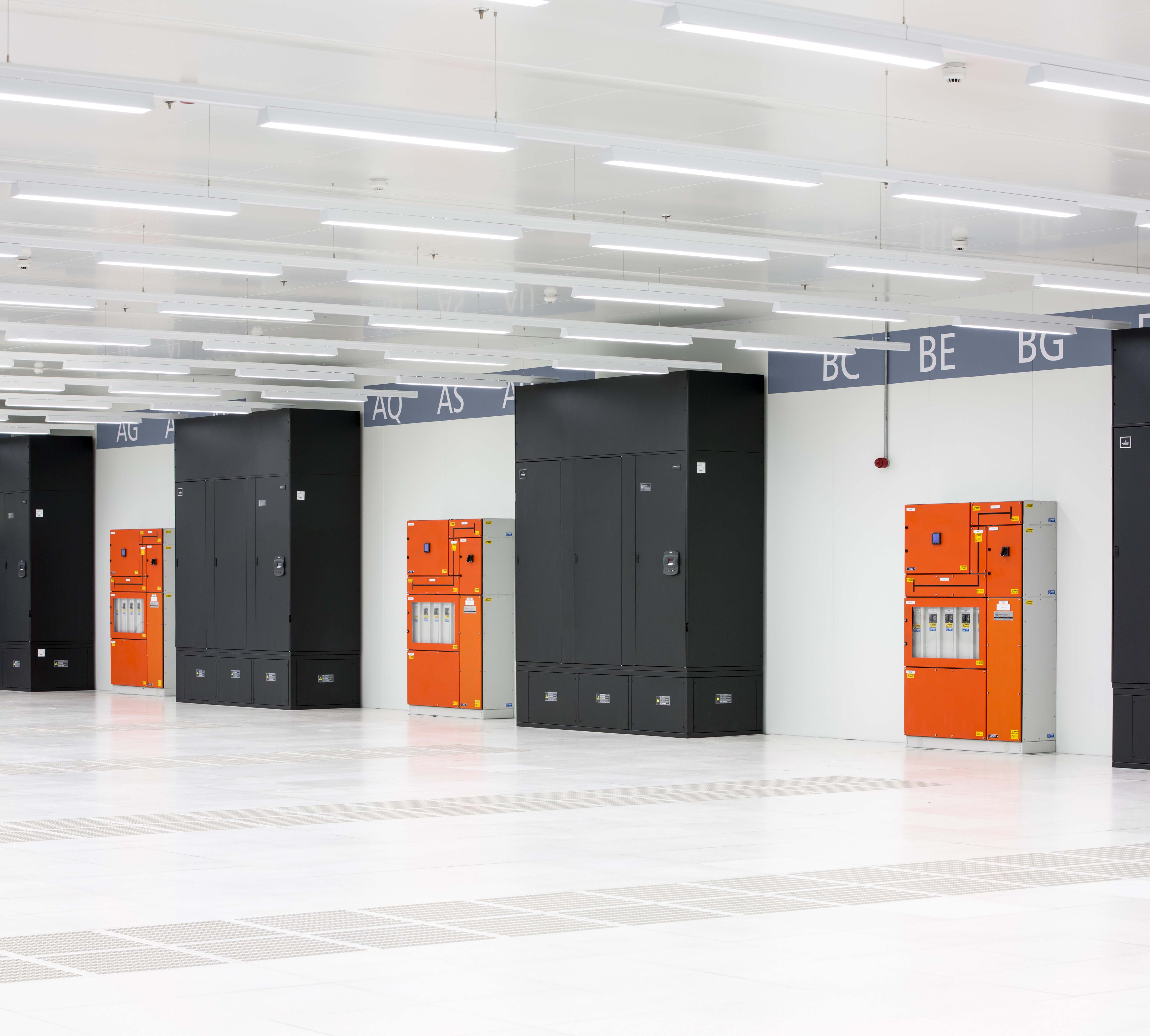 A row of orange and black lockers in a building.
