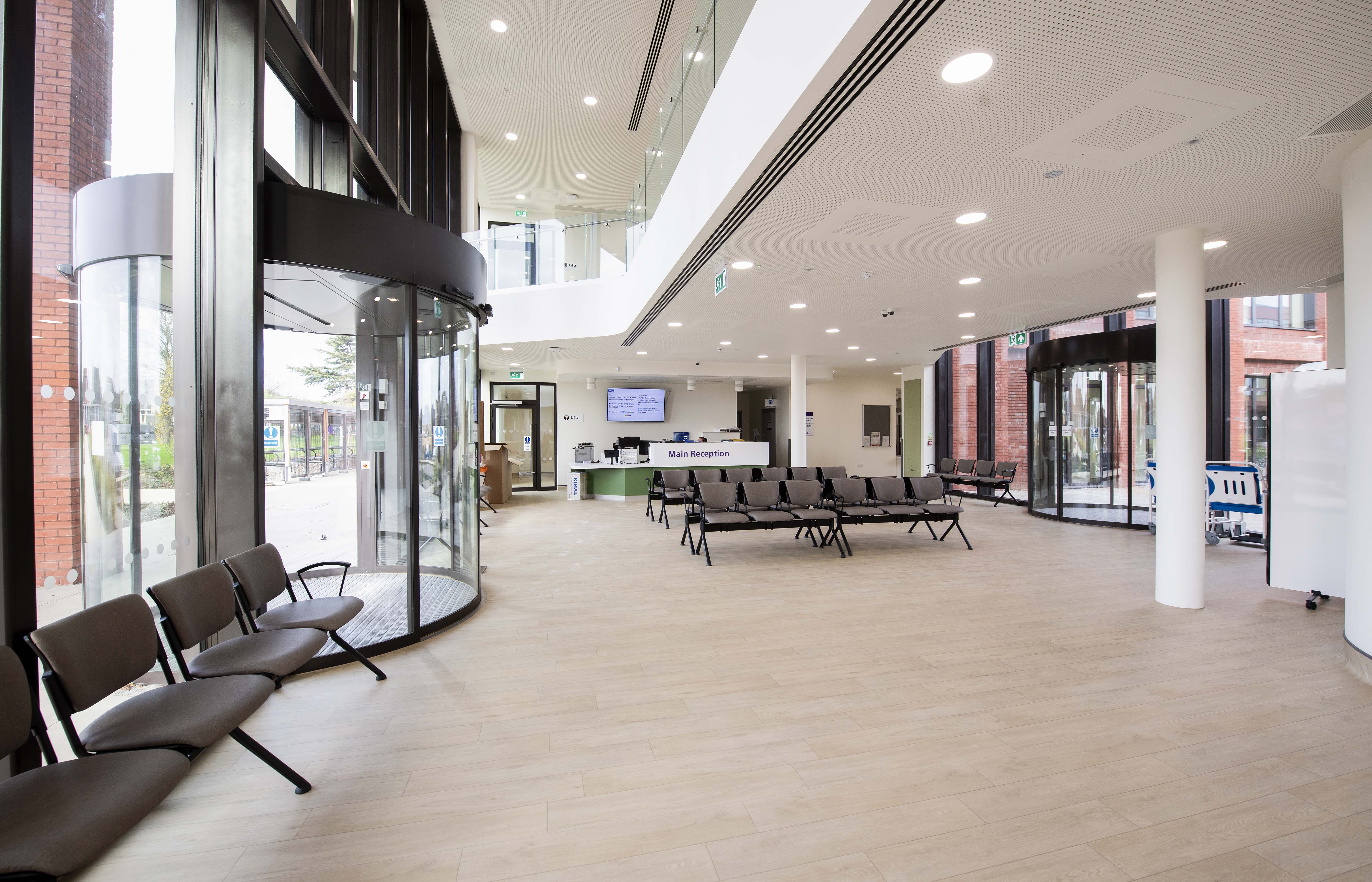 A waiting area with chairs and a flat screen tv.