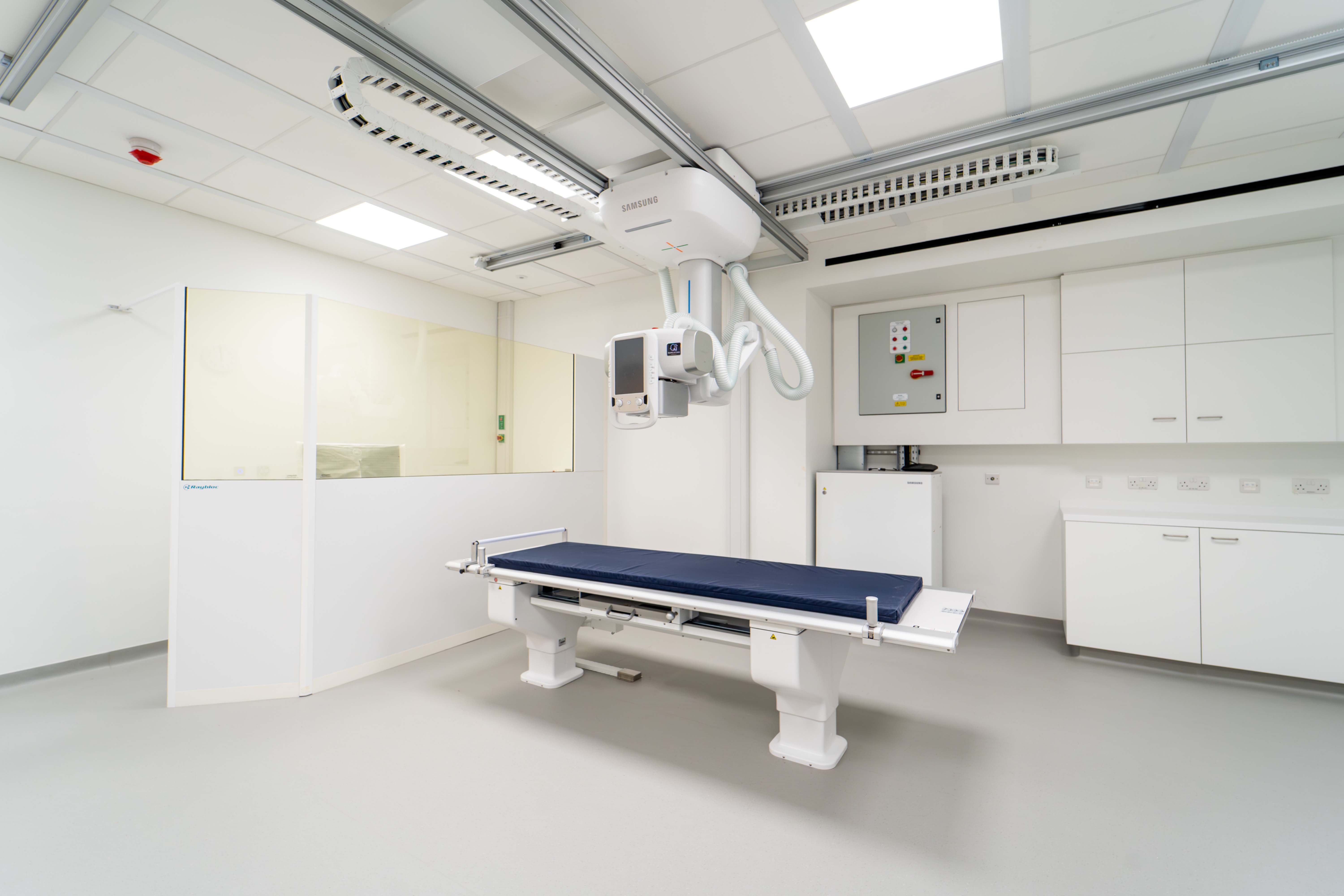 A hospital room with a hospital bed in the middle.