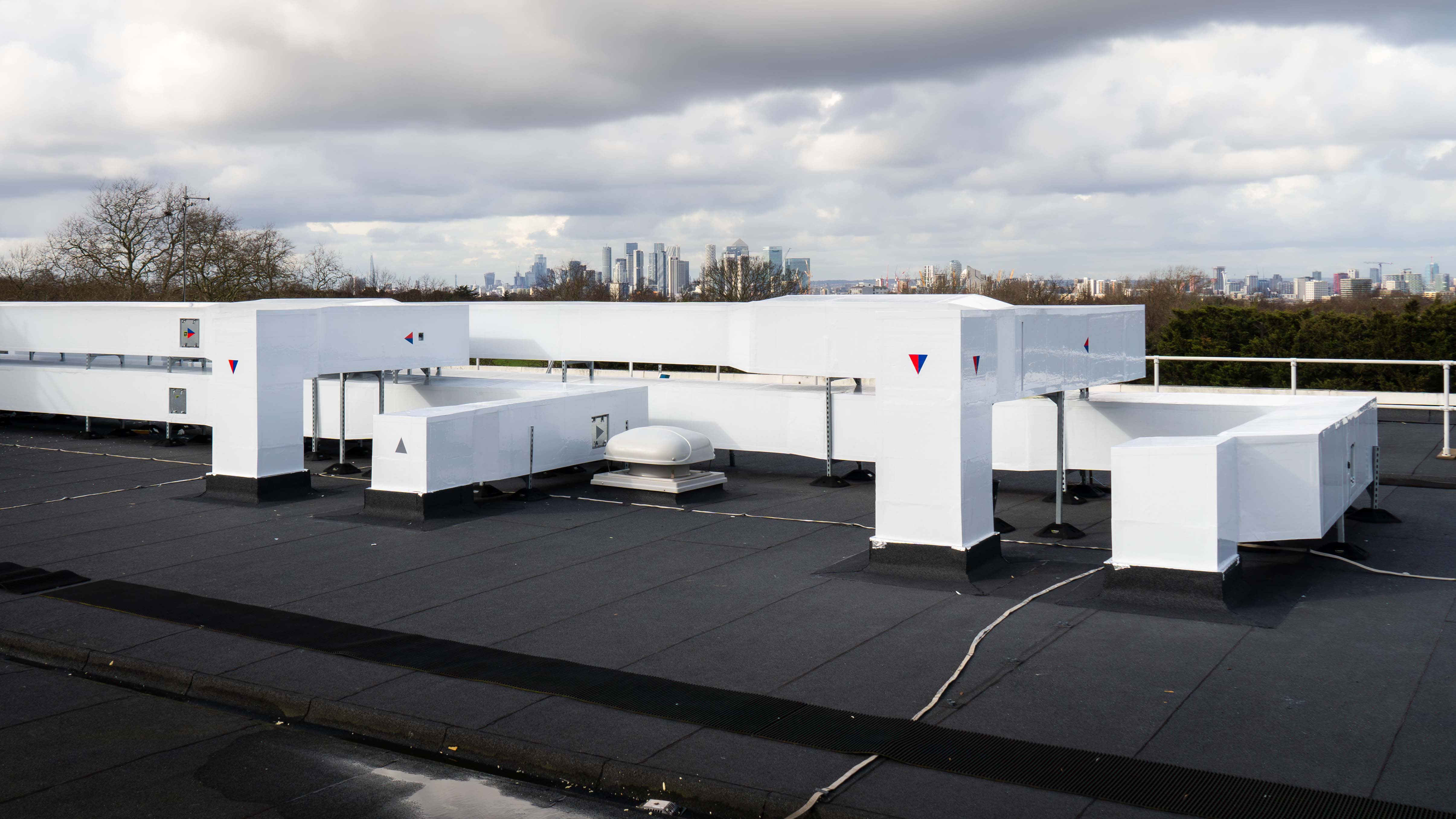 The roof of a building with a lot of white structures.