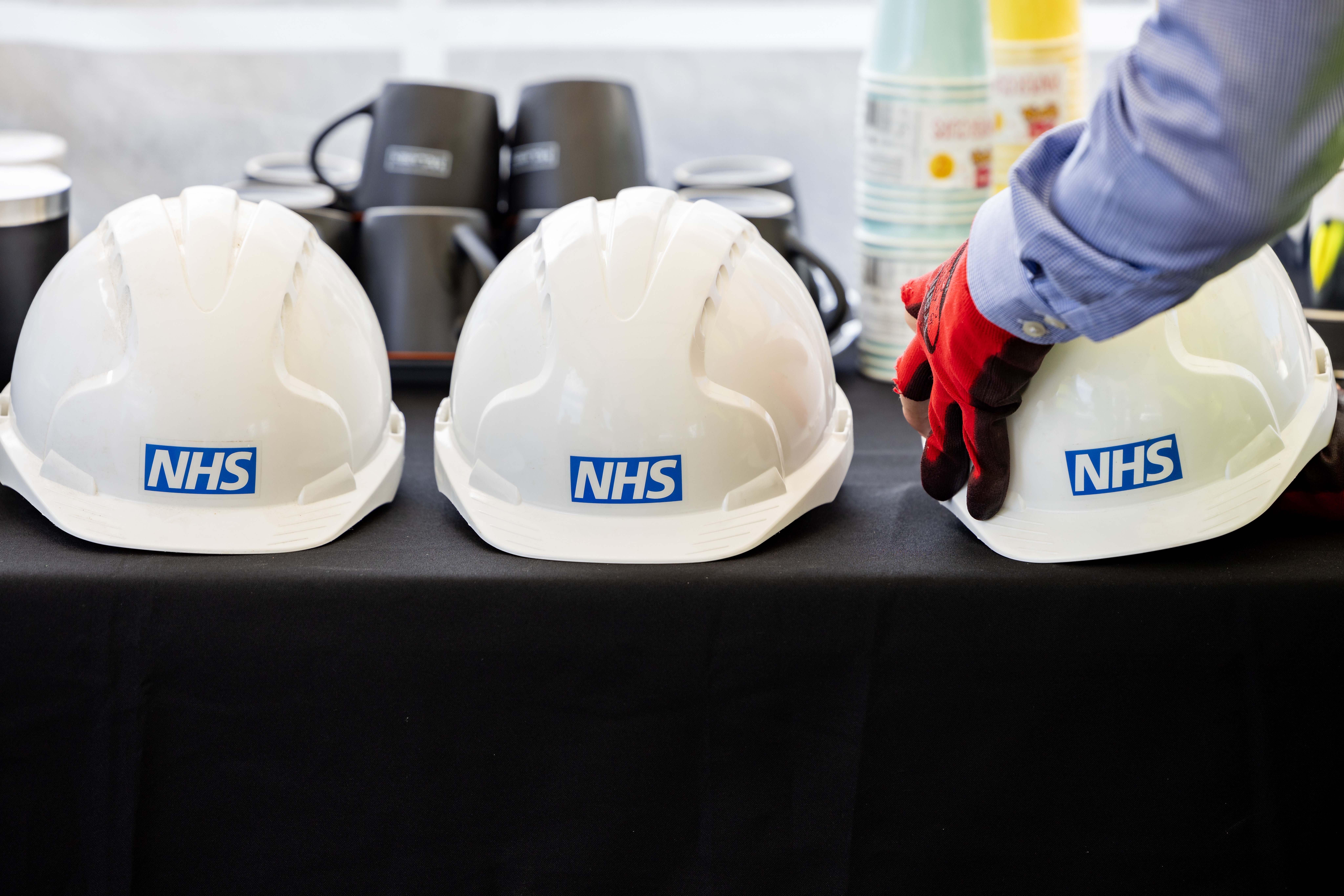 Three hard hats sitting on top of a table.