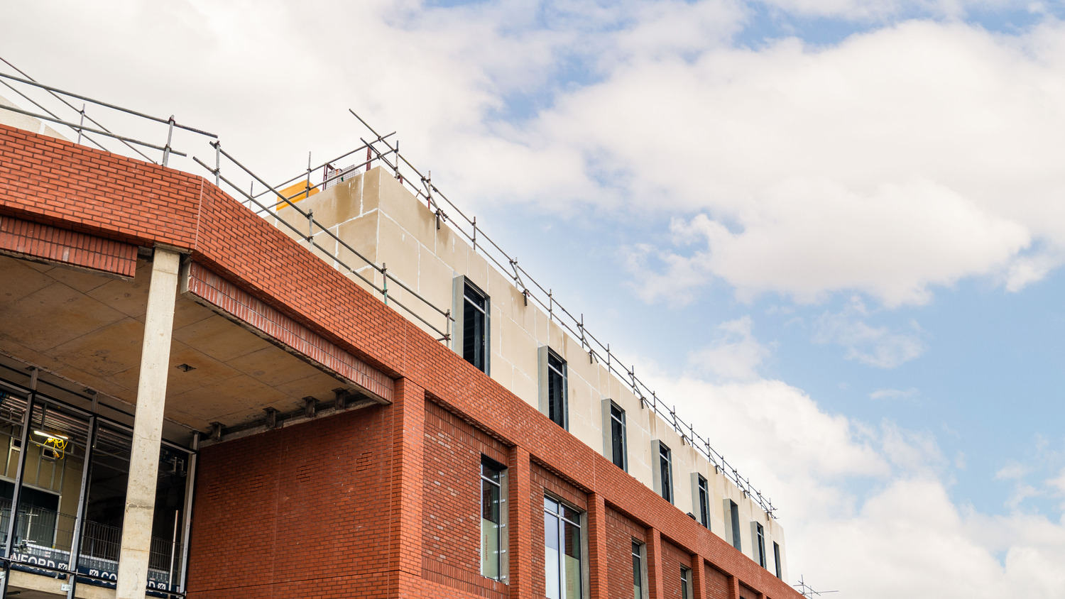 A red brick building with a clock on the top of it.