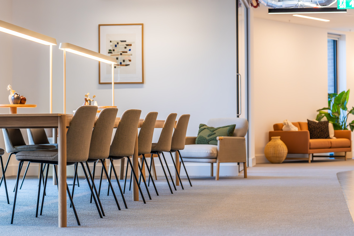 A long table with a bunch of chairs around it.