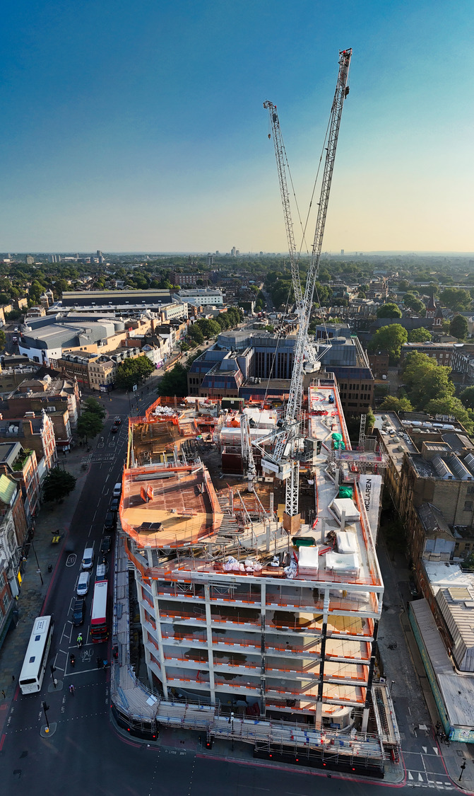 A large building under construction in the middle of a city.