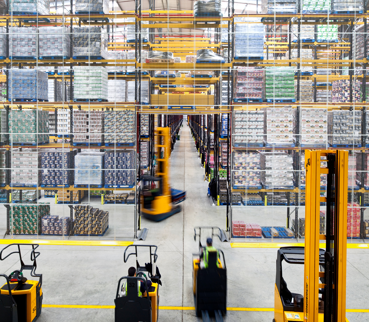 A large warehouse filled with lots of pallets.