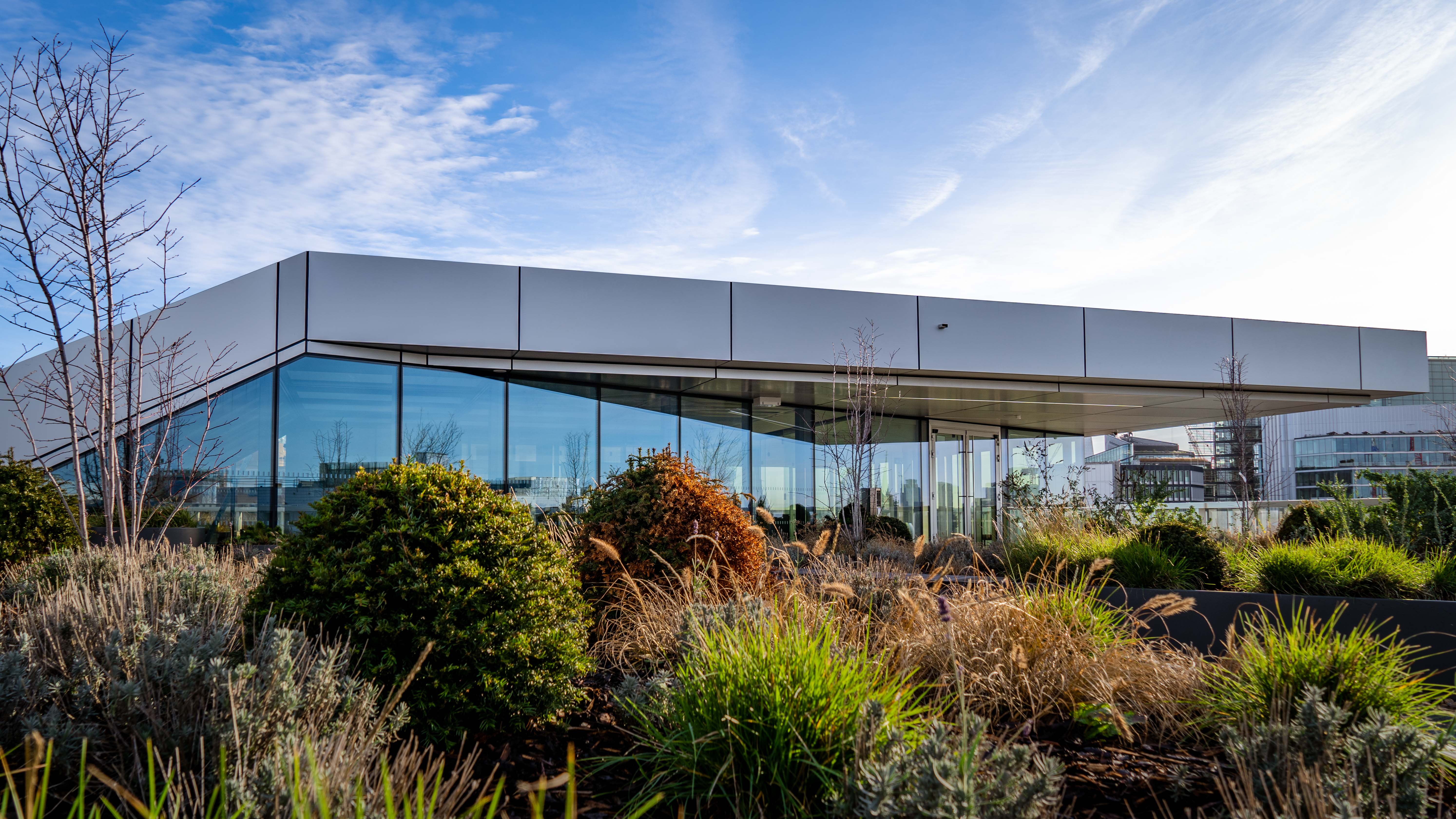 A building that has a lot of plants in front of it.