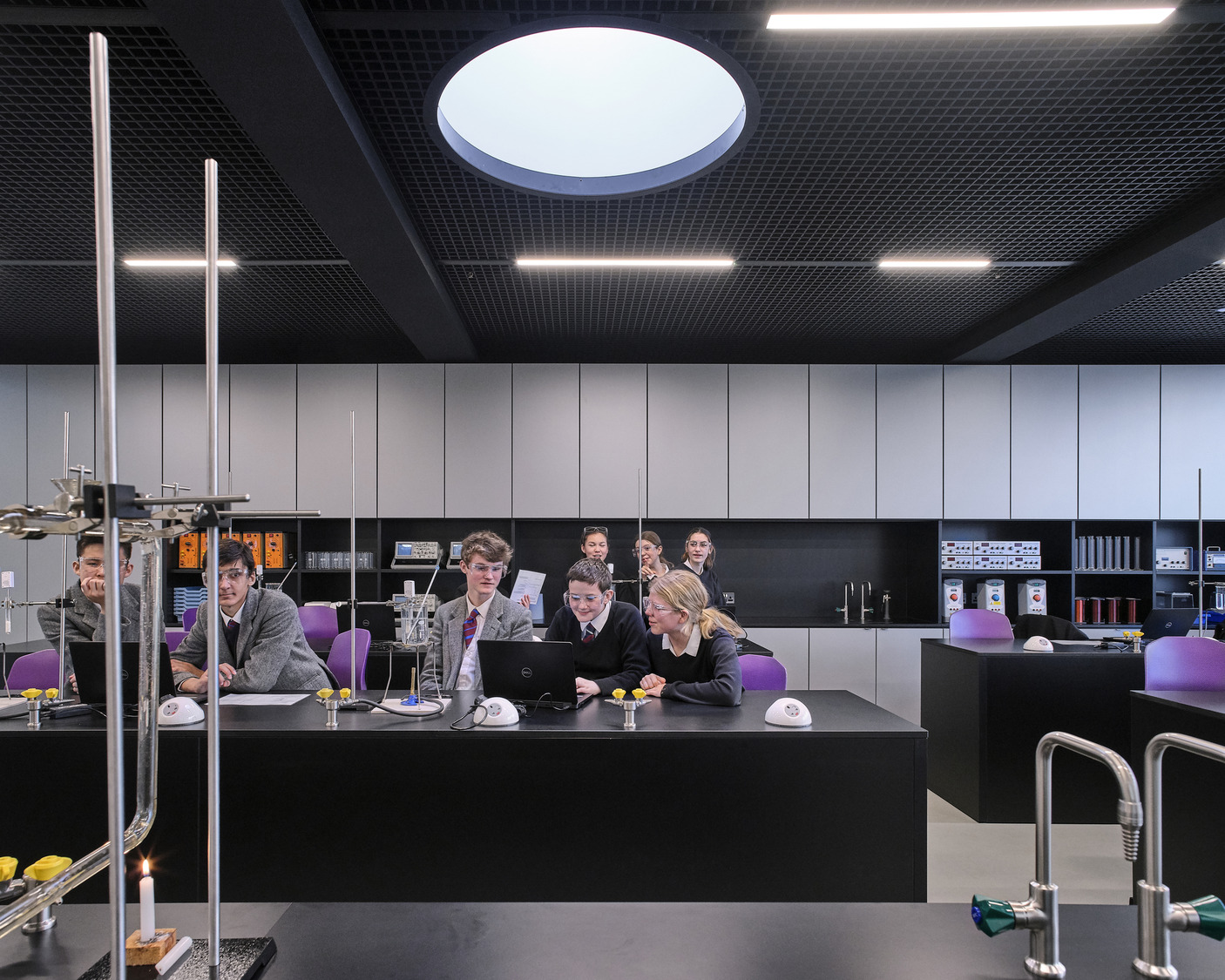 A group of people sitting around a table in a room.