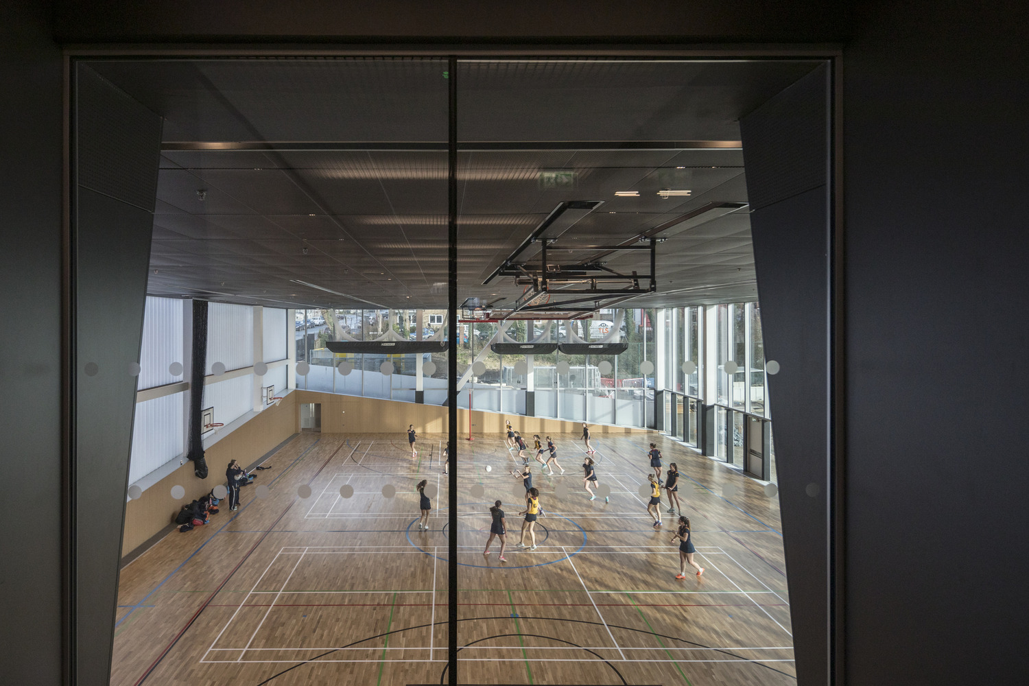 A group of people playing a game of basketball.