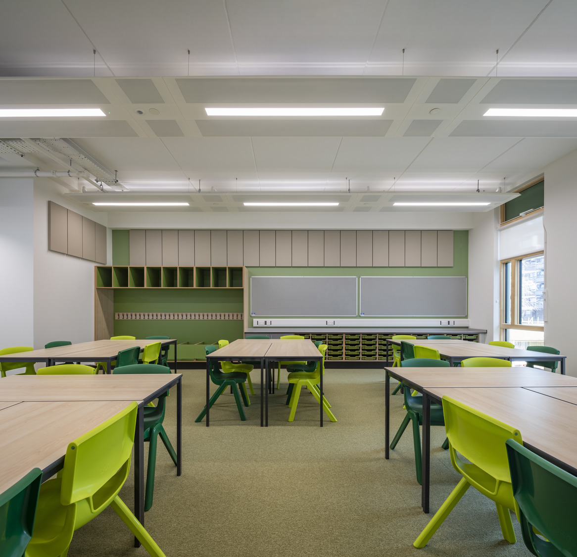 An empty classroom with desks and chairs.