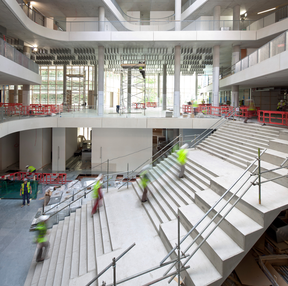 A group of people walking up and down some stairs.