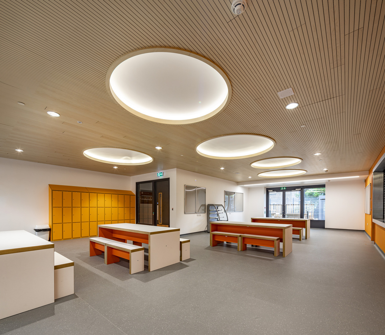 A large room with a lot of tables and benches.