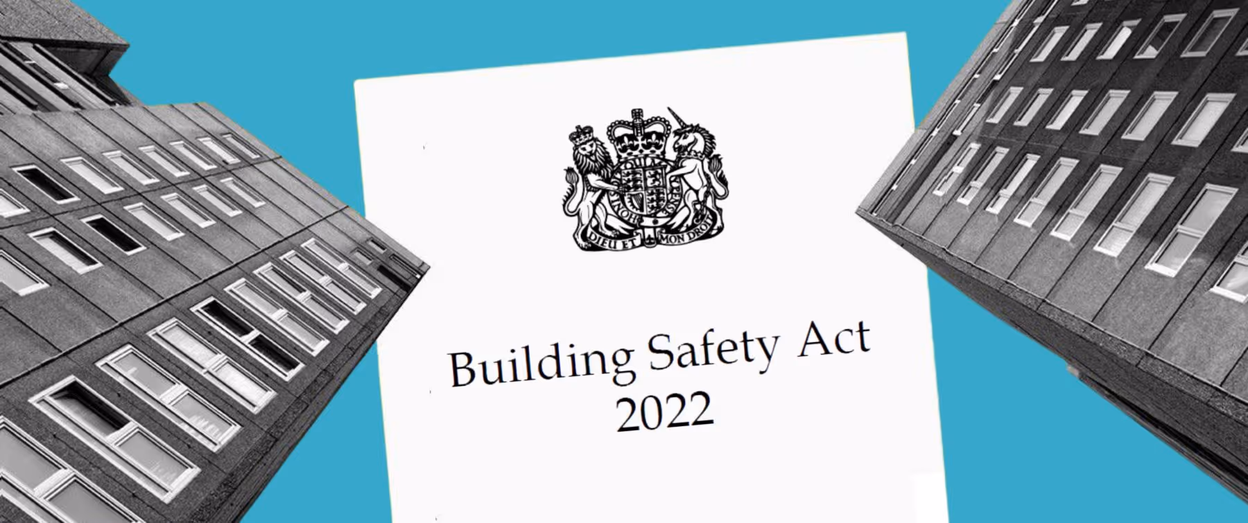 A building safety act sign in front of some tall buildings.