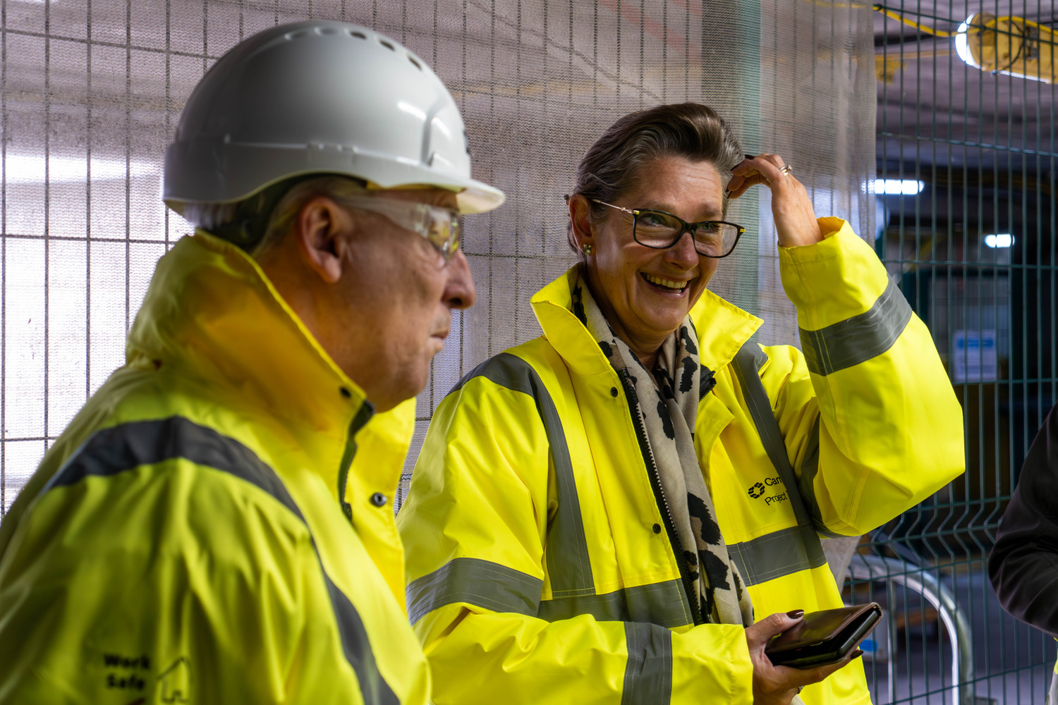 A group of men in yellow jackets and hard hats.