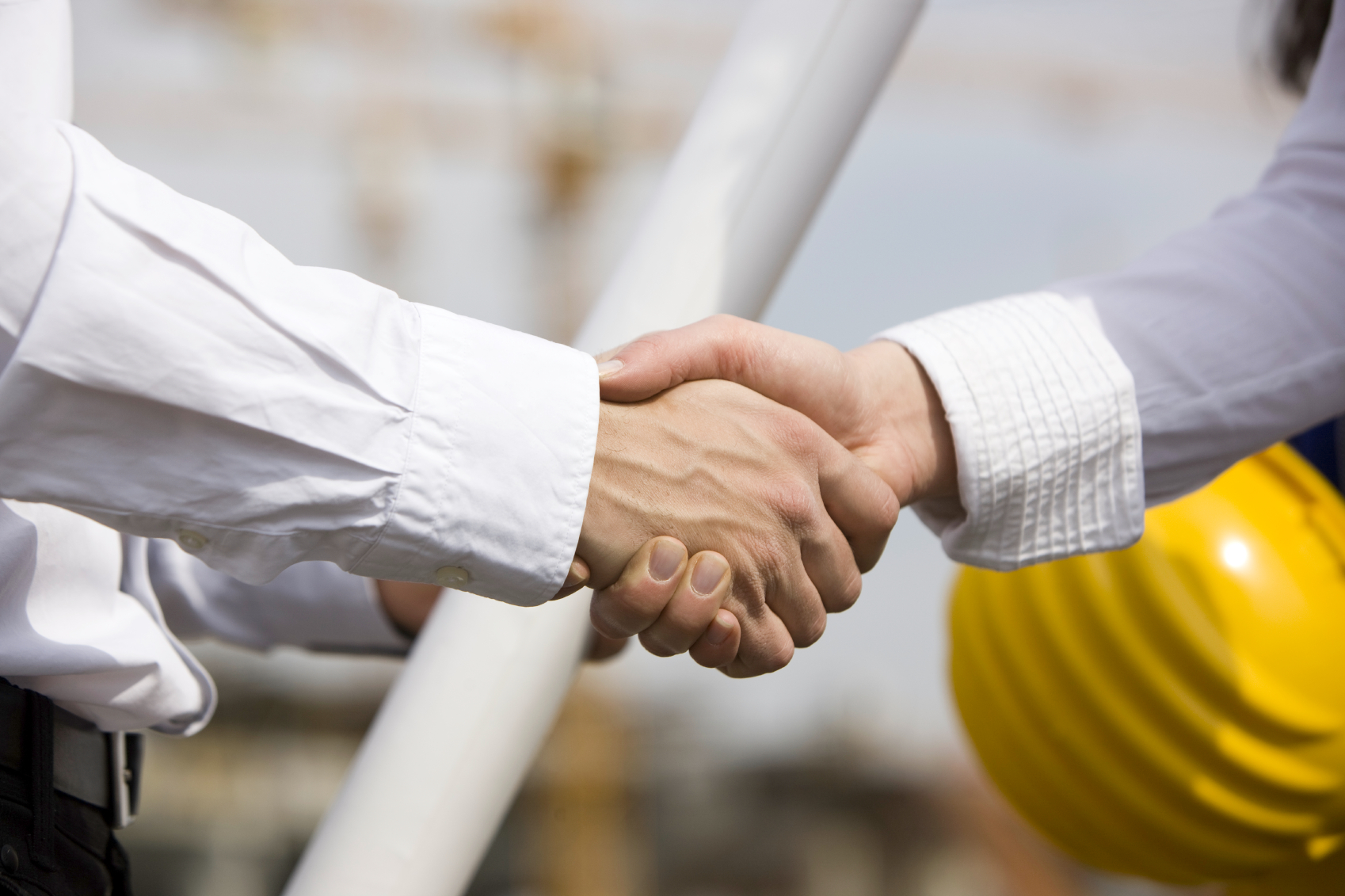 A close up of two people shaking hands.
