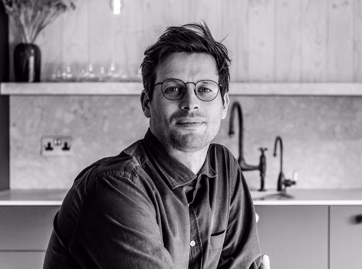 A black and white photo of a man in spectacles