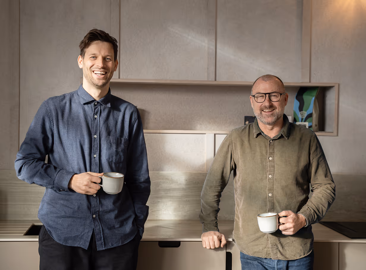 Two men having tea and smiling
