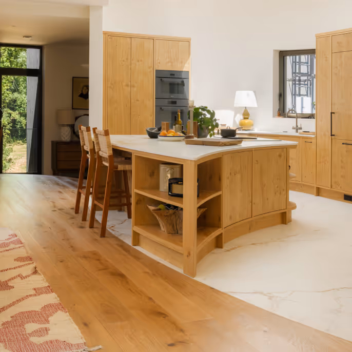 A kitchen with light brown wood work