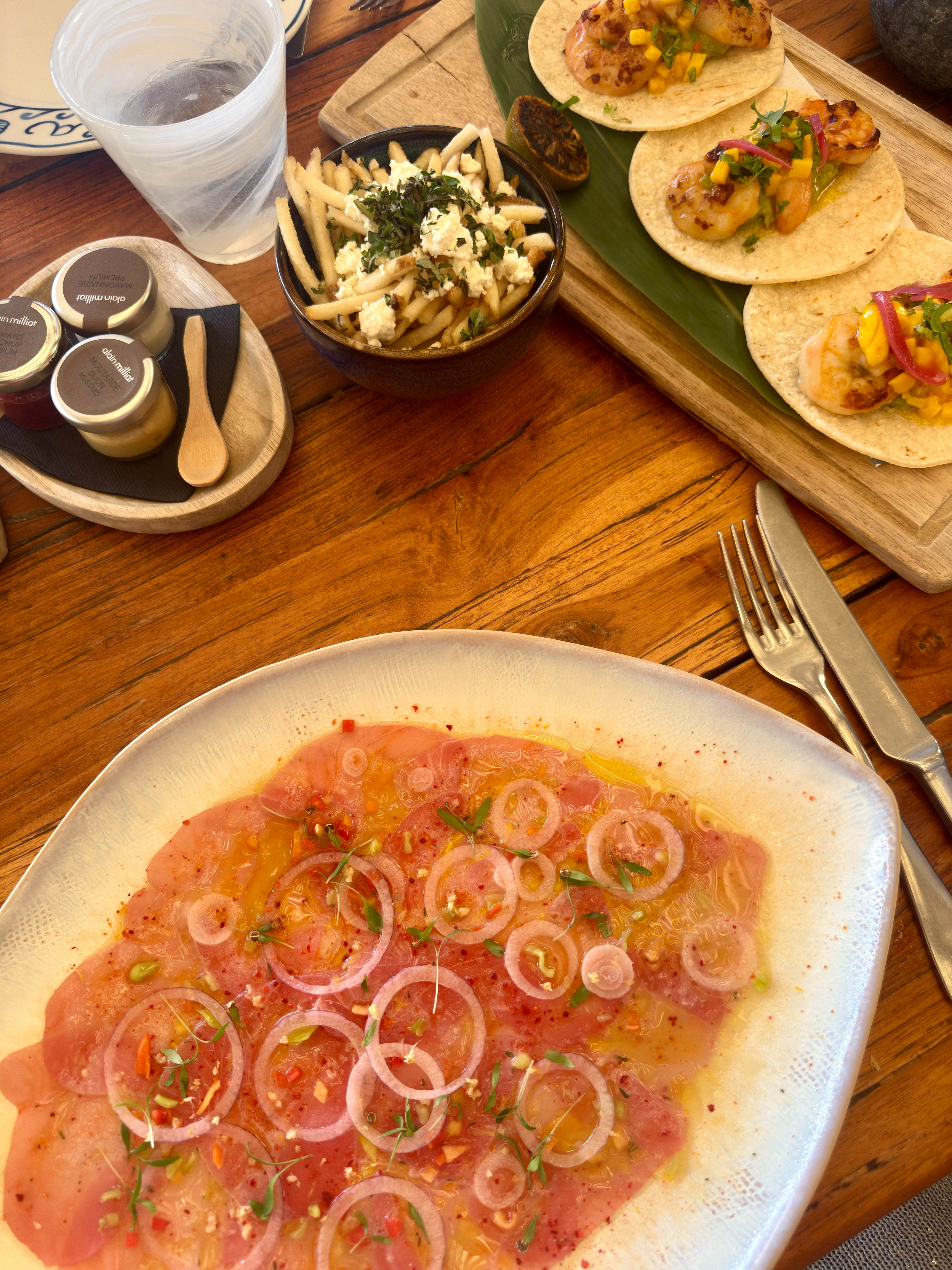 barths.webp Lunch at Gyp Sea Beach Club featuring fresh seafood, shrimp tacos, and fries in St. Barths.