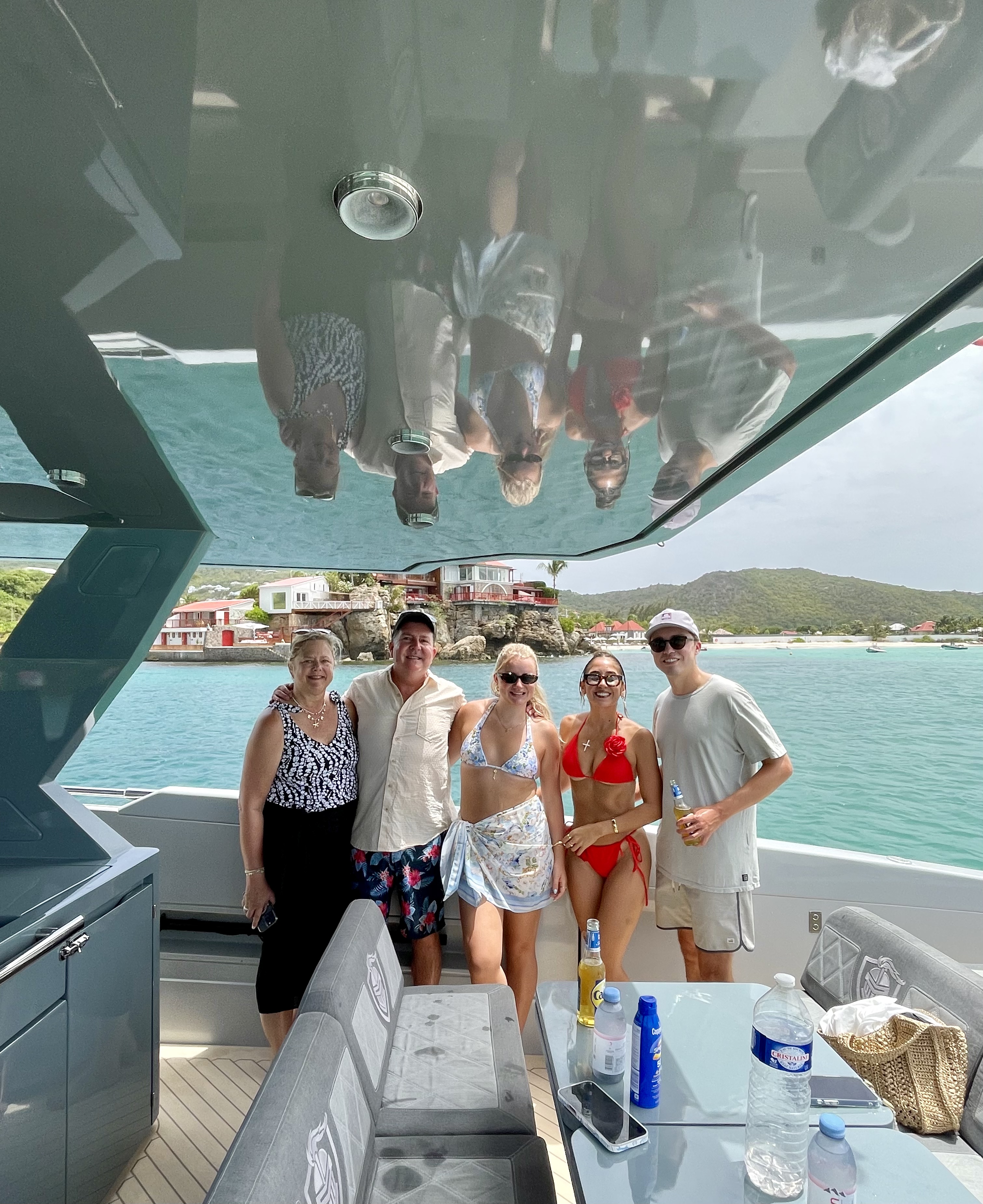 Family enjoying a private boat charter on the turquoise waters of St. Barths.