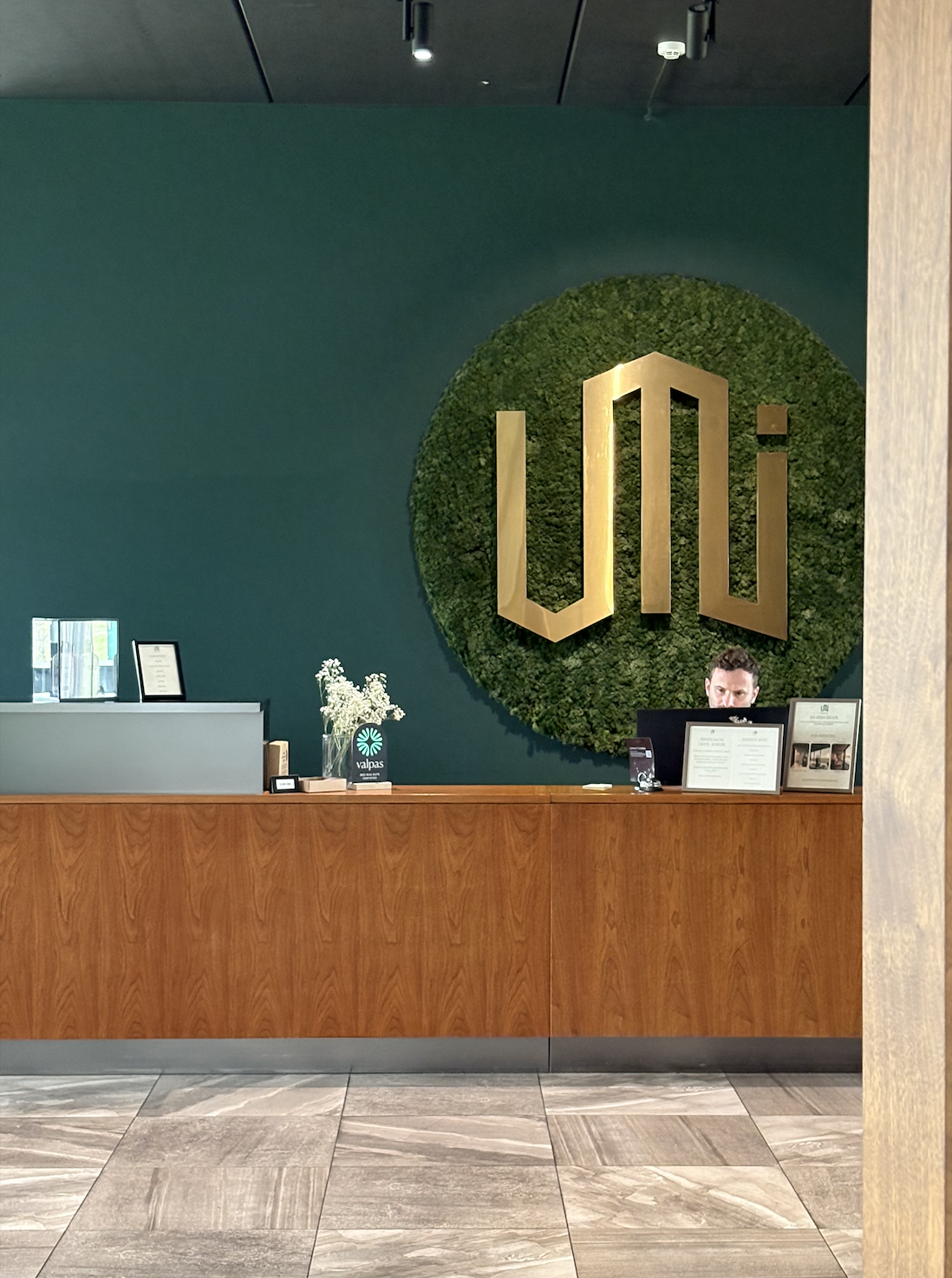 Reception area at UMI Hotel in South Iceland featuring the hotel's signature moss wall and modern Scandinavian design.