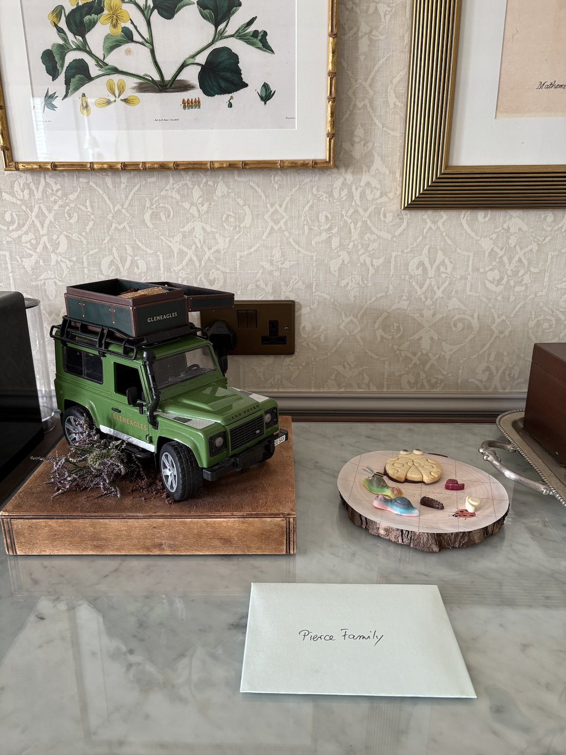 Personalized welcome gift featuring a miniature Land Rover and Scottish treats at Gleneagles Hotel.