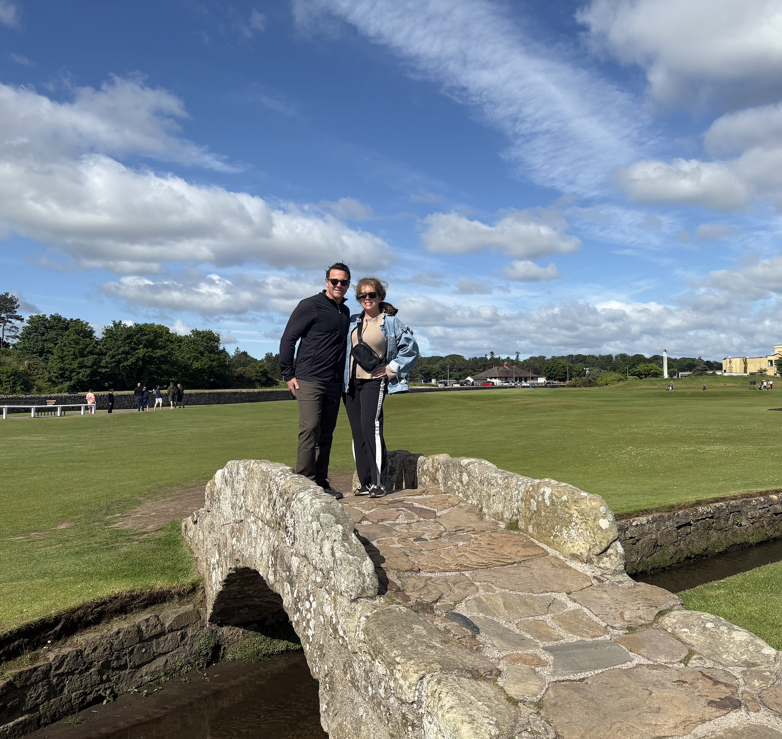 Golfer taking an approach shot on the historic Old Course at St Andrews, Scotland.