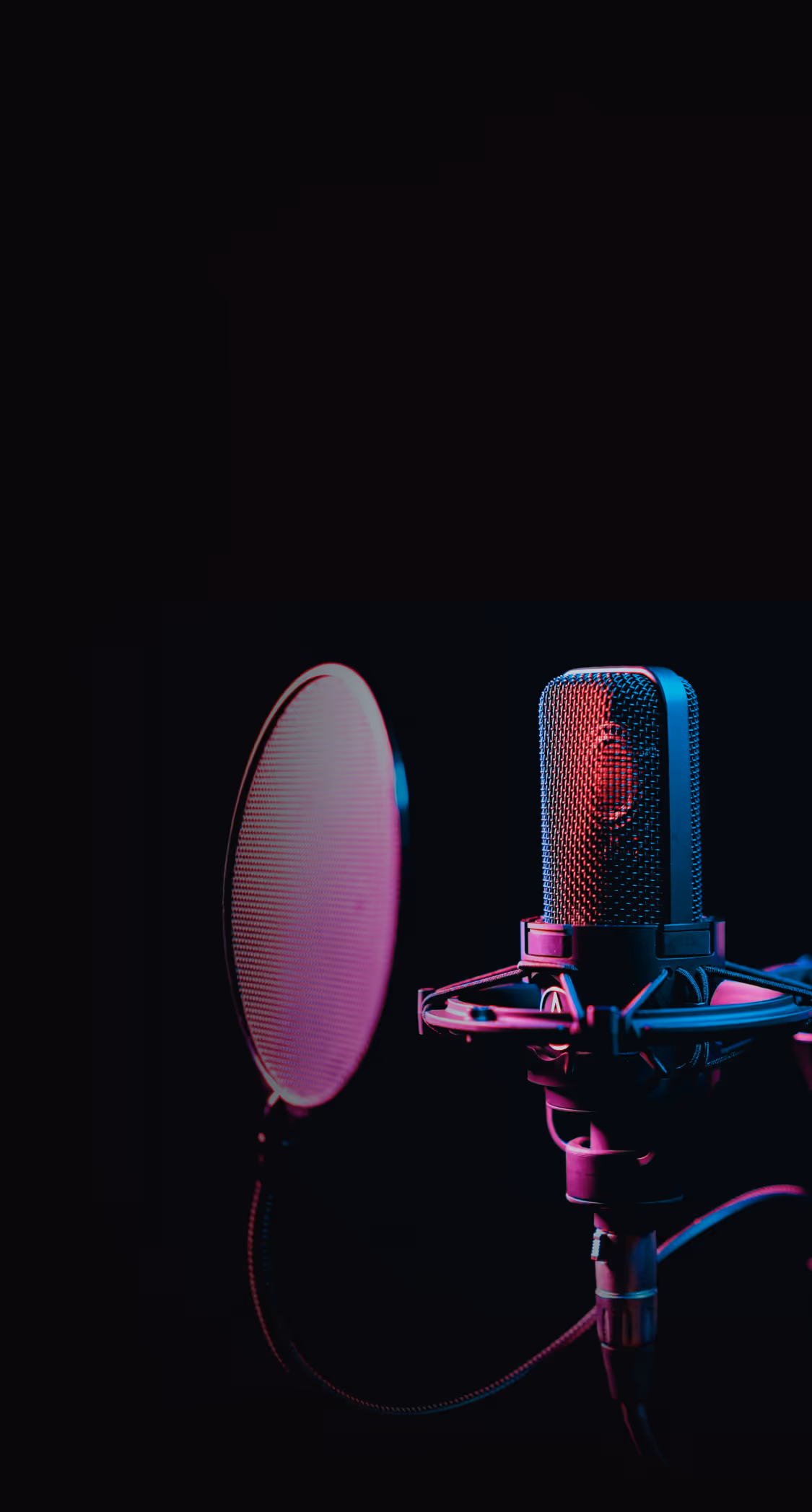A microphone with a red light in the background.