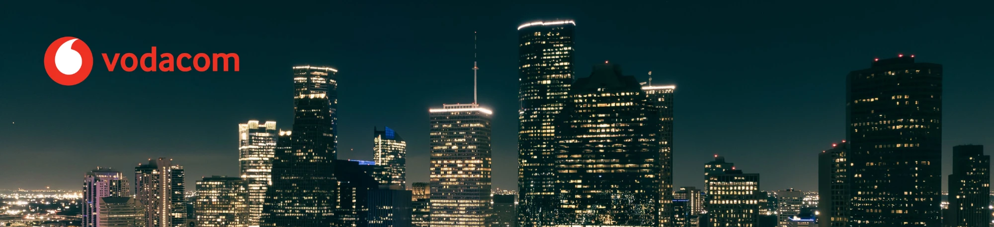 Vodacom over a night-time city skyline
