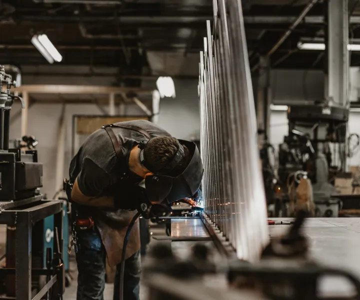 Welder in shop working on project