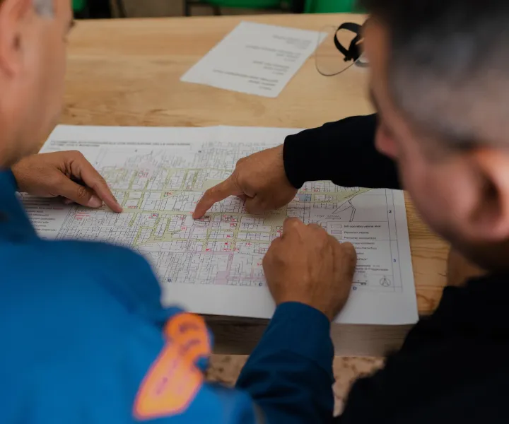 Two team members looking over blueprint