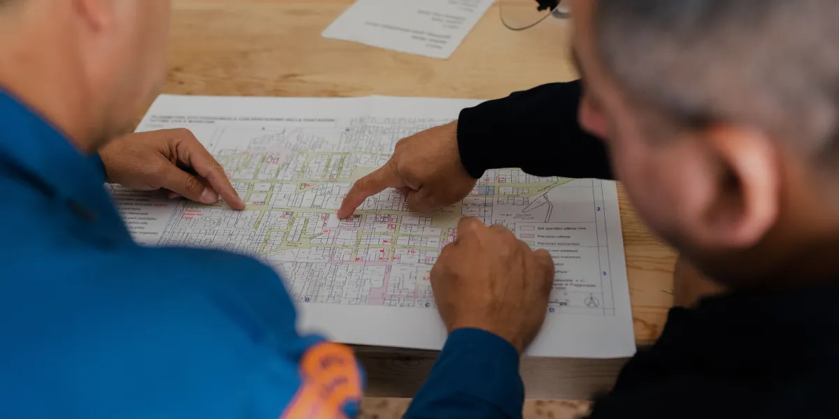 Two team members looking over blueprint