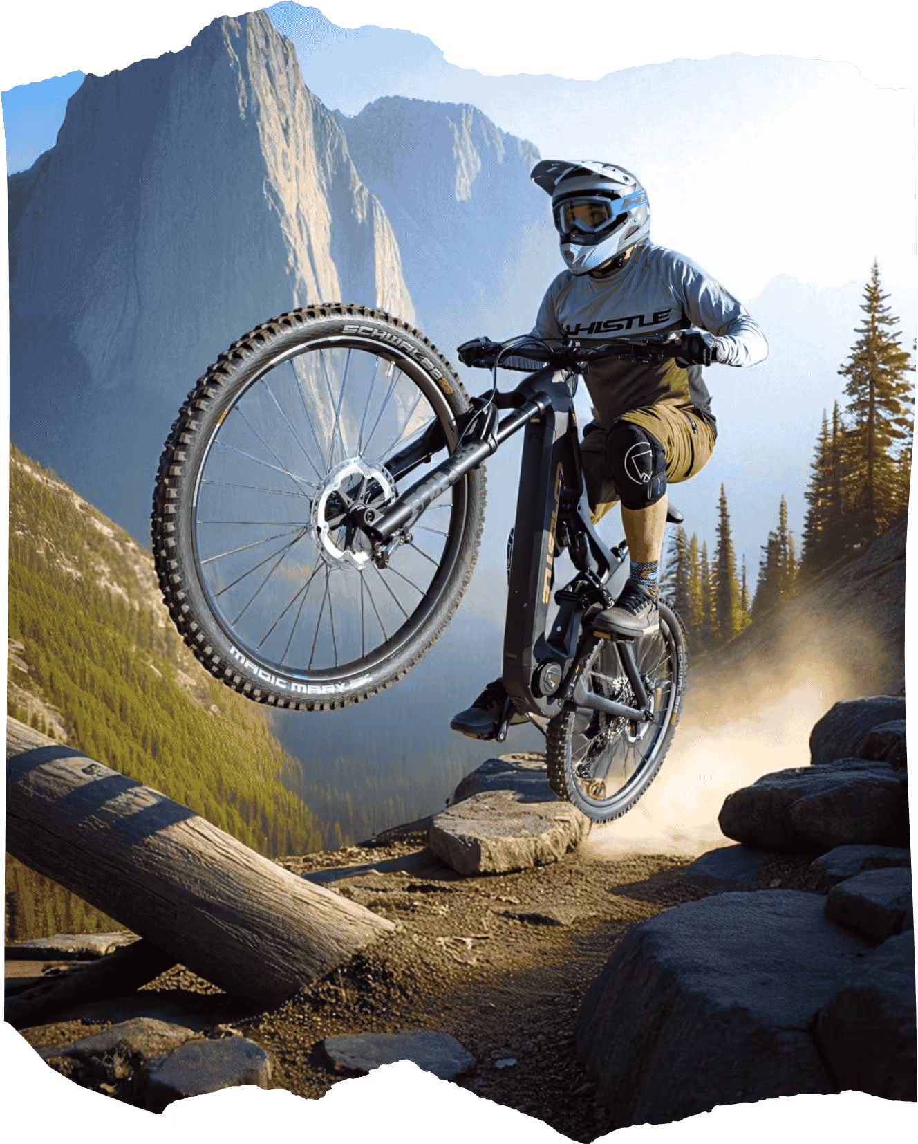 Whistle e-MTB with premium aftermarket components performing wheelie on mountain trail