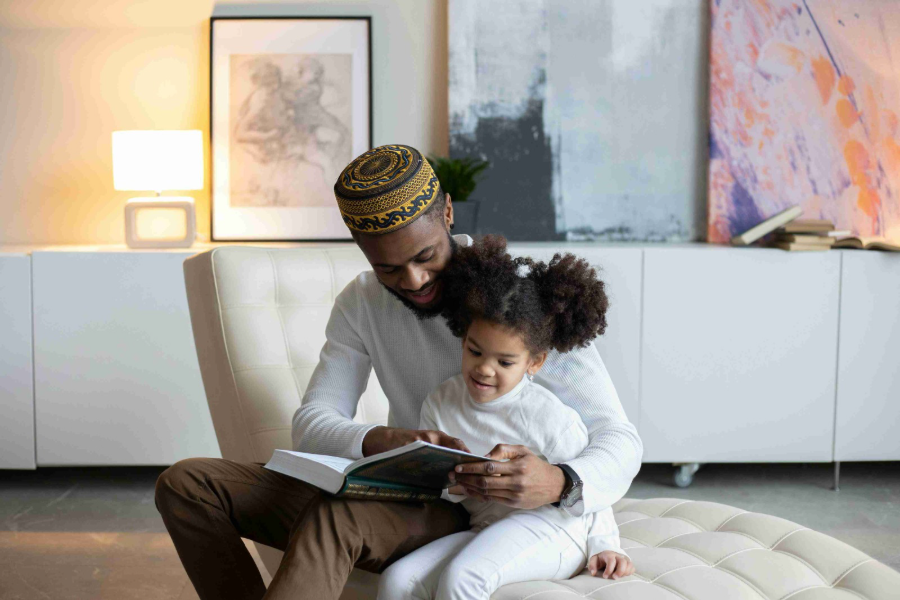 Islamic Stories About Prophets blog image: Muslim father and daughter reading a book together 