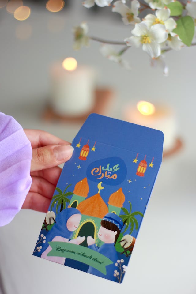 Teaching Children about Eid Traditions Blog Image: Hand holding an Eid Mubarak Card