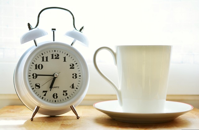 Dua before Sleeping & Dua or Waking Up Blog image: An alarm clock and a mug placed on a table 