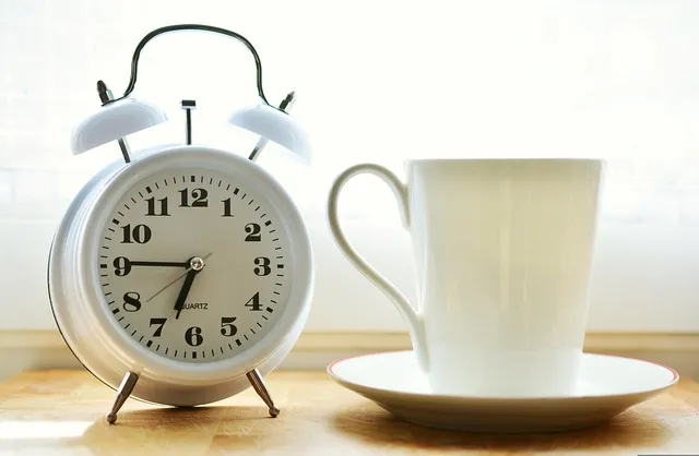 Dua before Sleeping & Dua or Waking Up Blog image: An alarm clock and a mug placed on a table