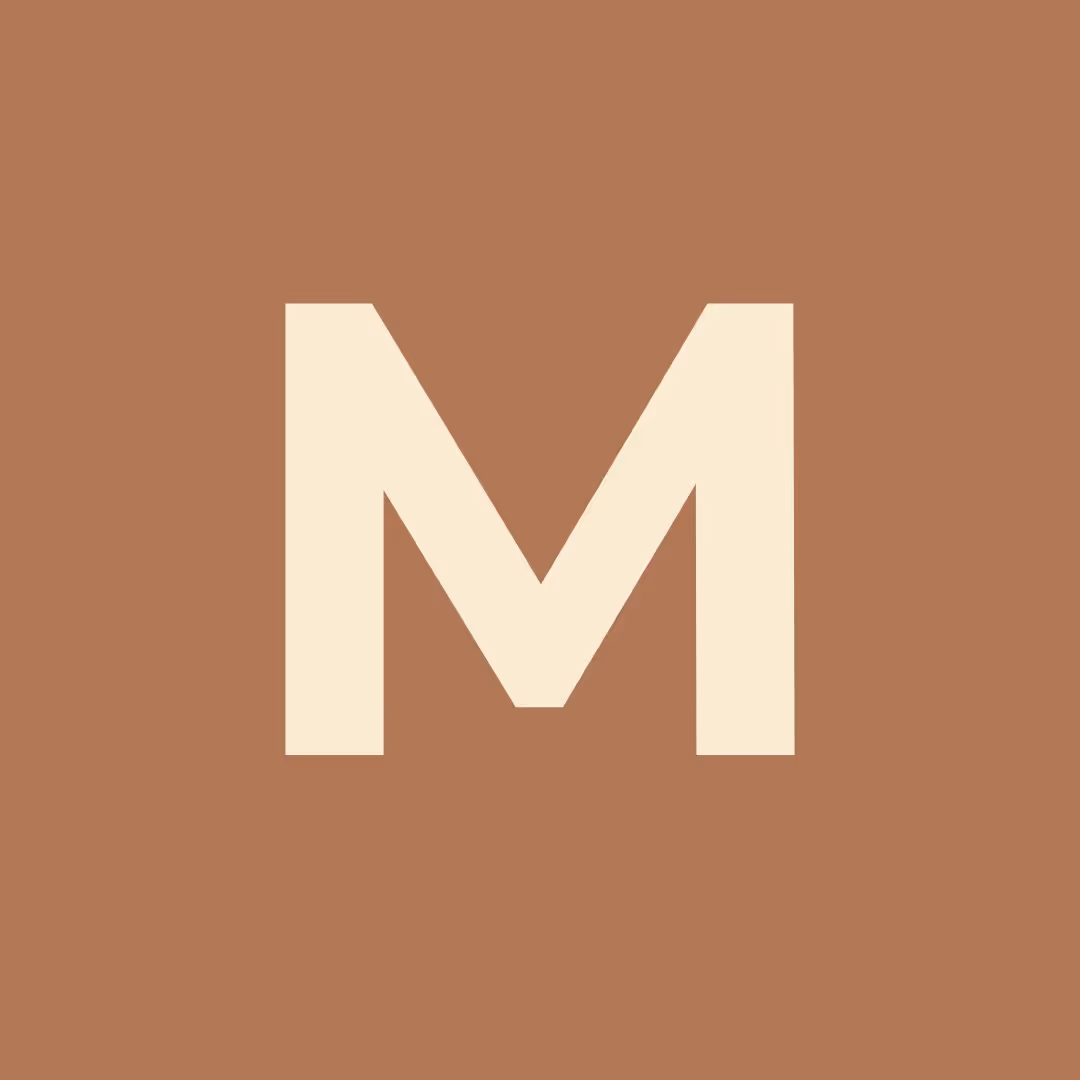 Bold cream letter M centered on a solid brown background.