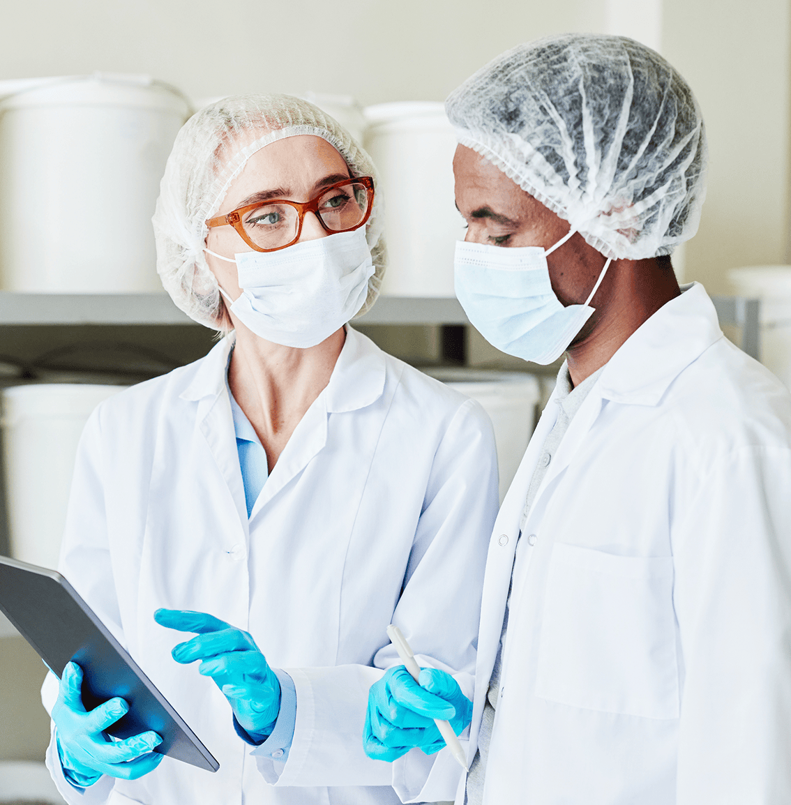 Two lab employees reviewing data in a cleanroom