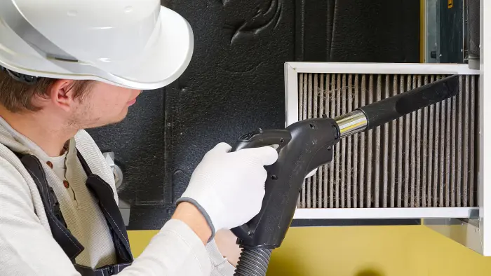 Professional home air duct cleaning is carried out with a vacuum in a Tacoma, WA home.