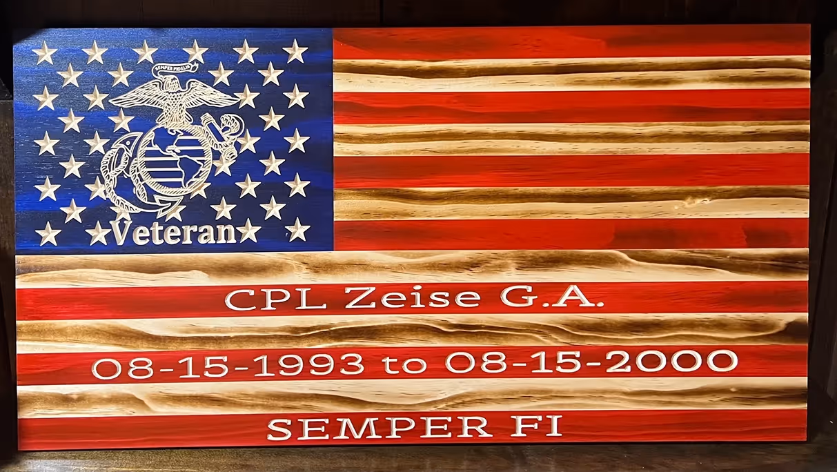 Wooden American flag with Marine Corps emblem, text honoring CPL Zeise G.A. and service dates with Semper Fi.