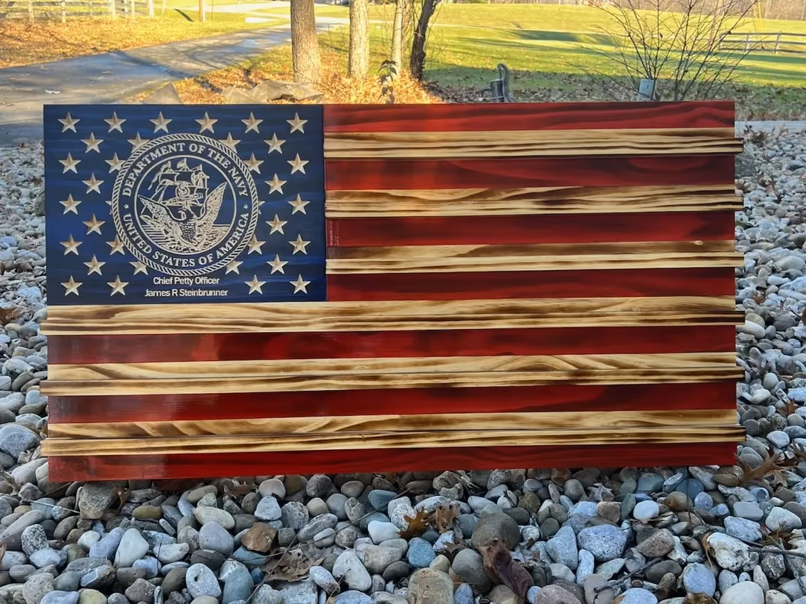 Wooden American flag with Department of the Navy emblem and Chief Petty Officer James R Steinbrunner text.